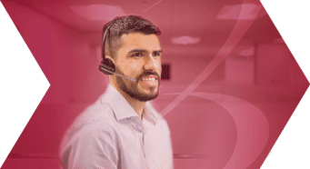 Young professional man is wearing a headset and smiling in an office providing expert software solution support